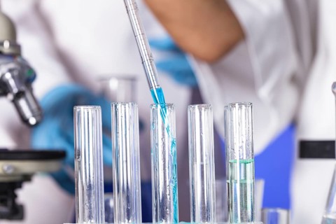 The blue drop from pipette in laboratory tubes