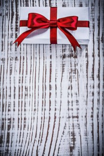 Copyspace of packed giftbox on vintage wood board holidays concept