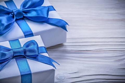 Present boxes on wooden board horizontal view celebrations concept