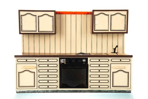 Miniature vintage toy kitchen isolated over white background