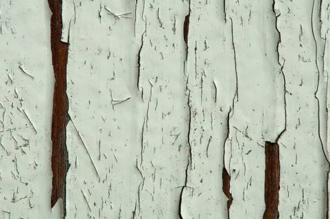 Cracked old painted white wooden wall