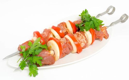 Prepared food for barbecue (shish kebab) - seasoned meat with vegetables on skewers