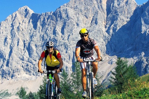 A man and a woman on a mountain bike in an alpine landscape, 30, 35, years