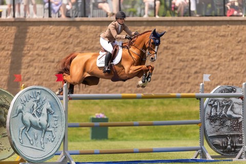 Elena A. Haas, from the United States and riding Claude, compete in the 1.60m Grand Prix during The