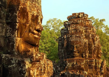 Giant stone faces at Bayon Temple at sunrise, Angkor Wat, Cambodia, Asia