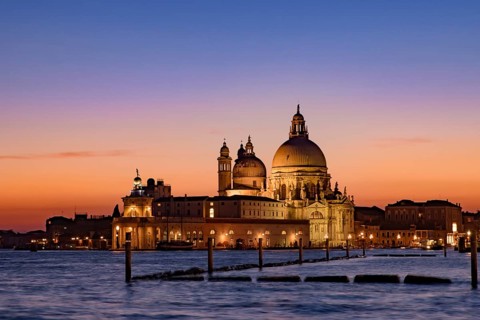 Santa Maria della Salute (Saint Mary of Health) at sunset time, a Catholic church in Venice, Italy,