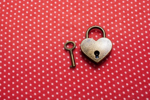 Heart shaped lock and key on an abstract background