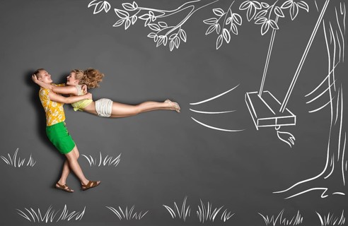 Happy Valentine's Day love story concept of a romantic couple against chalk drawings background.