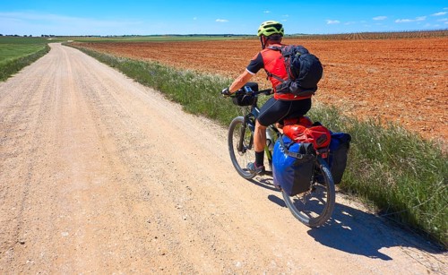 Biker pilgrim by Camino de Santiago in bicycle at Saint James Way of Levante