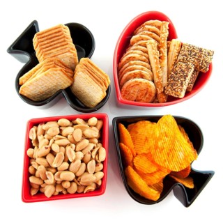 Playing card symbols as hearts clubs daimonds and spades with salted snacks