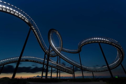 Roller coaster with illuminated design against the evening sky, Tiger and Turtle, Duisburg, North