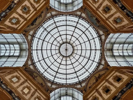 Round stained-glass windows and arches on the ceiling of the Vittorio Emmanuel Gallery. Milan,