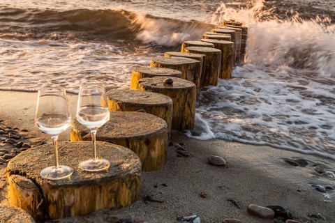 Wine on the baltic sea beach at sunset