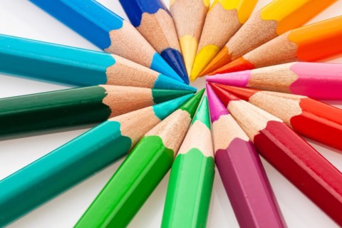 Lots of different coloured pencils on a white background