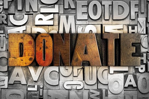The word DONATE written in vintage letterpress type