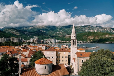 Church of the Holy Trinity near St. John Cathedral among old houses with red roofs. Budva,