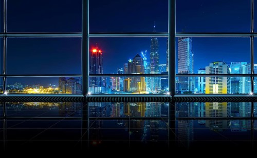 Modern empty and clean office interior with glass windows, Kuala Lumpur city skyline background,