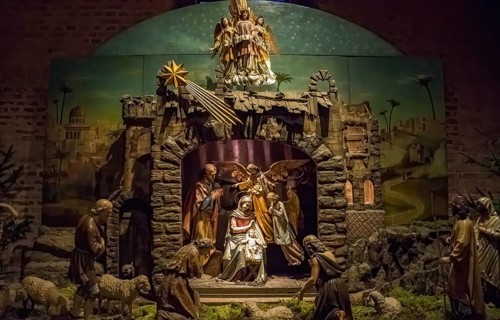 Traditional Christmas nativity scene with beautiful figures made out of wood. The birth of Jesus
