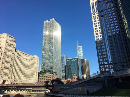 City skyline with skyscrapers and river under a bright blue sky, chicago, illinois, usa
