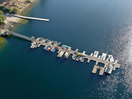 Aerial view of Miramar Lake small pier with pedal boat, small motor boat. Lake with popular