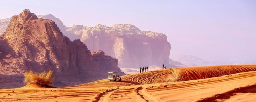 Jordan, Wadi Rum, November 2, 2022: Jeep safari in desert. Tourists and off-road car trace on dune