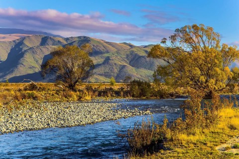 Valley at the foot of the Clay Cliffs and a slow river. Fabulous country of New Zealand. Travel to