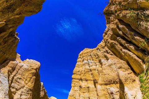 Scenic Clay Cliffs. Bright blue sky above the tops of picturesque rocks. Travel to New Zealand. The