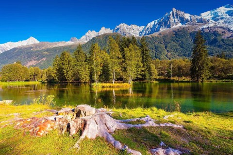 The mountain resort of Chamonix, Haute-Savoie. City Park is illuminated by sunset. The lake