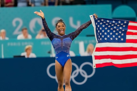 Simone Biles (USA) of the United States celebrates with the fans after winning the Artistic