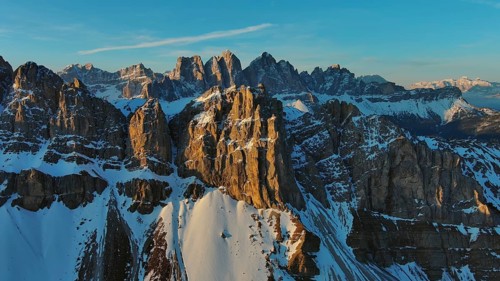 Aerial view of amazing rocky mountains in snow at sunrise, Dolomites, Italy, Europe