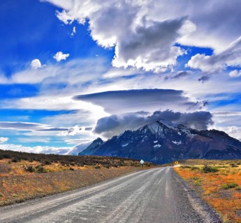 Stunning sunset in the Chilean Patagonia. Incredible clouds over the mountain glaciers. The dirt