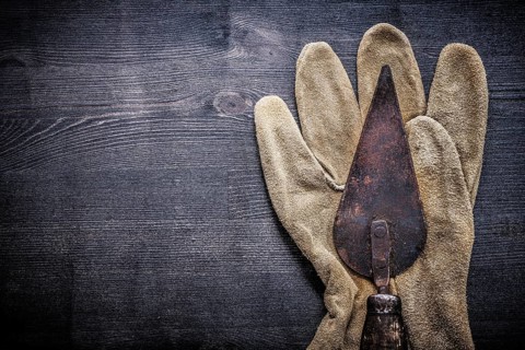 Horizontal view vintage tools putty spattle on glove