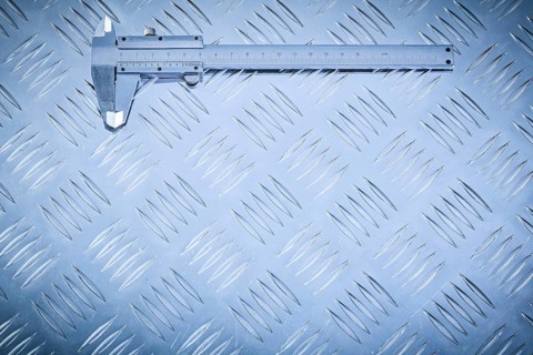 Vernier caliper on grooved metal plate construction concept