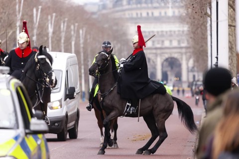 Mounted horse guards in ceremonial uniforms on a street in the City of Westminster, Greater London,