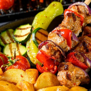 Shish kebab with various vegetables and spices Country potatoes