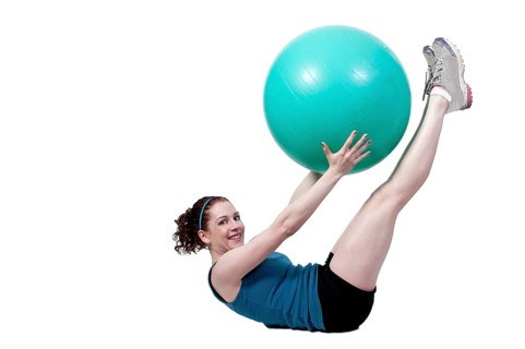 A beautiful young woman working with an aerobic exercise ball