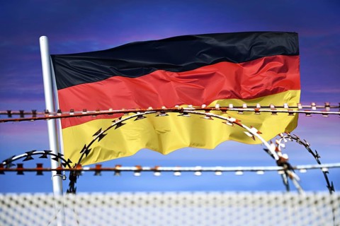 German flag in front of barbed wire, symbolic photo for border controls and rejection at the German