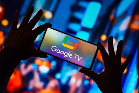 In this photo illustration, the Google TV logo is displayed on a smartphone screen