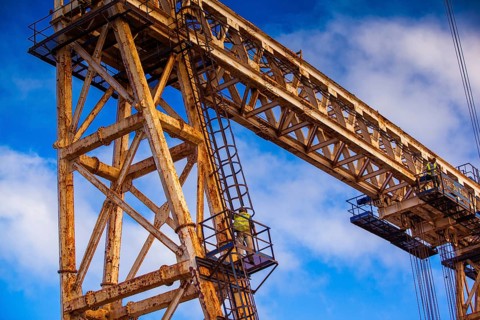 Worker climbing on a crane