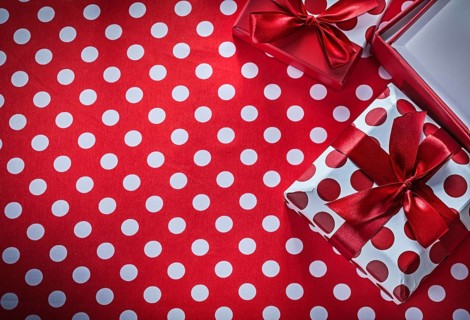 Present boxes on polka-dot red print background celebrations concept