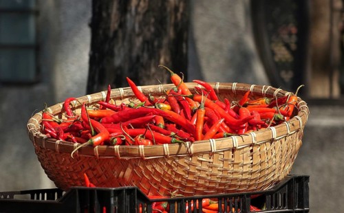 A basket with red hot chili peppers at a local market
