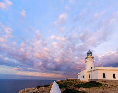 Menorca sunset in Faro Far de Caballeria Lighthouse at Balearic Islands es Mercadal