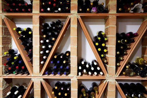 Wine Cellar from Mediterranean with bottles stacked in rows