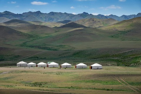 Traditional yurts between montains at sunset, Mongolia, Asia