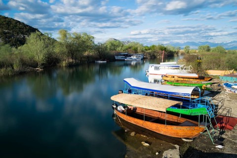 Colorful boats and sunny weather at Virpazar Harbor, Skadar Lake, Montenegro, Europe