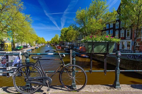 Bikes on the bridge that crosses the canal in Amsterdam, Netherlands