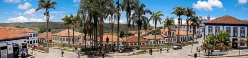 Panorama of traditional houses and palm tree lined street in historic center of Diamantina on a