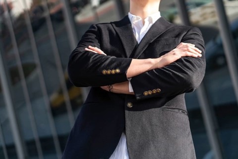 Photo of business man in classic black suit, shirt holding hands folded Achievement career wealth