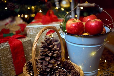 Christmas composition with red apples, gifts and gingerbread. Christmas in retro style. Vintage