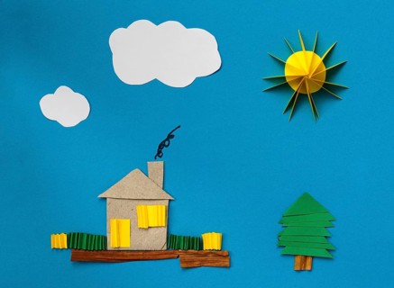 House made ??of paper over blue paper background